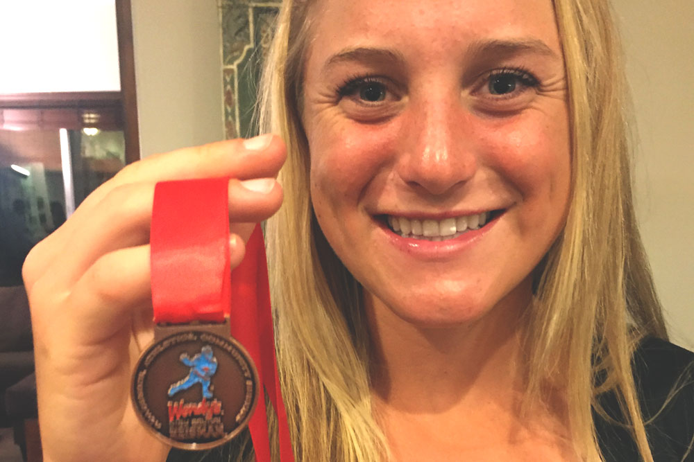 Chloe Henderson with Heisman Medal